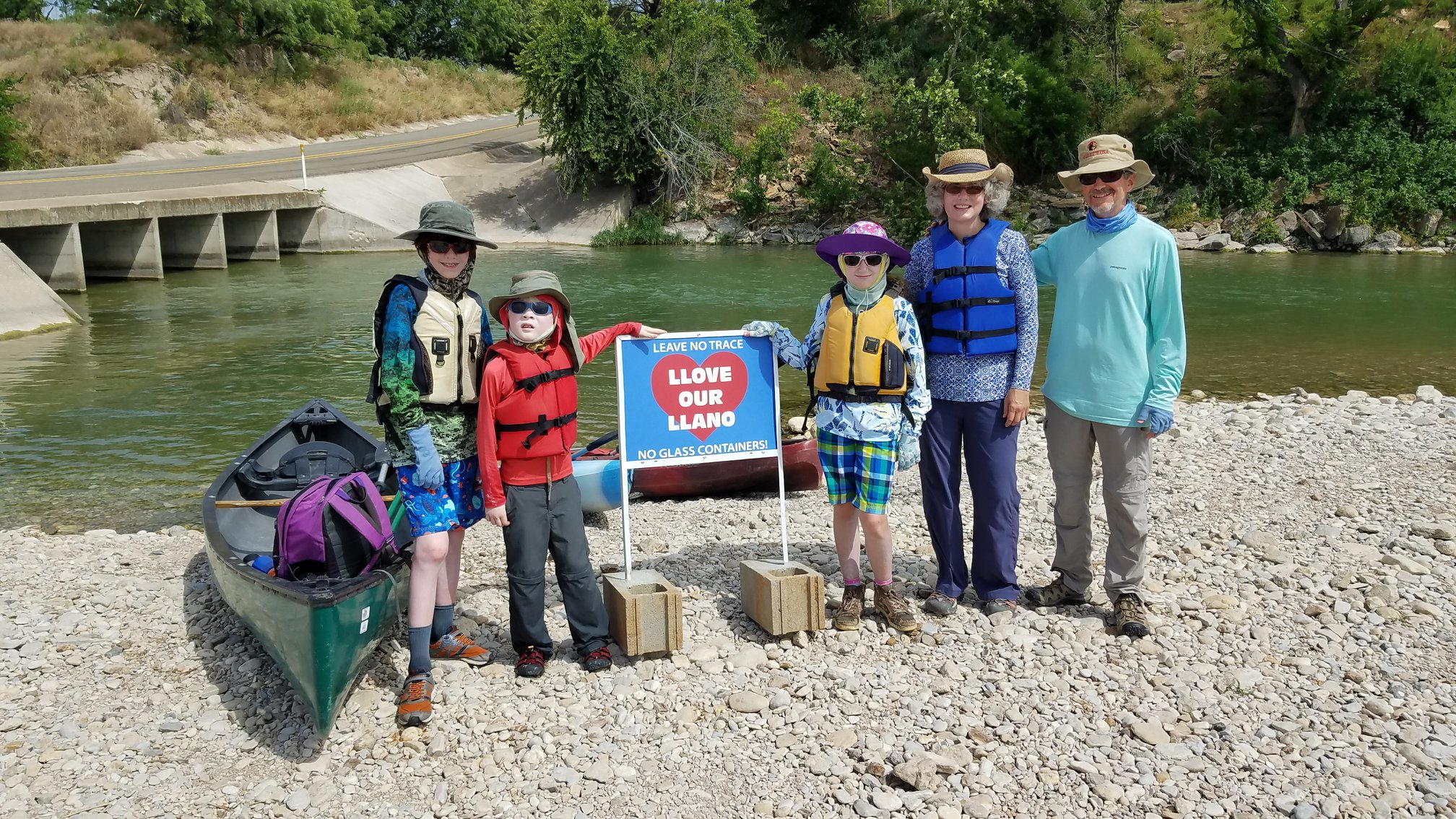 Volunteers and children at a Llano River trout release